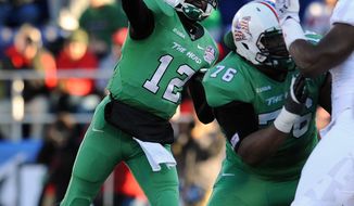 Marshall quarterback Raheem Cato (12) throws as Maryland applies pressure in the first half of the Military Bowl NCAA college football game on Friday, Dec. 27, 2013, in Annapolis, Md.(AP Photo/Gail Burton)