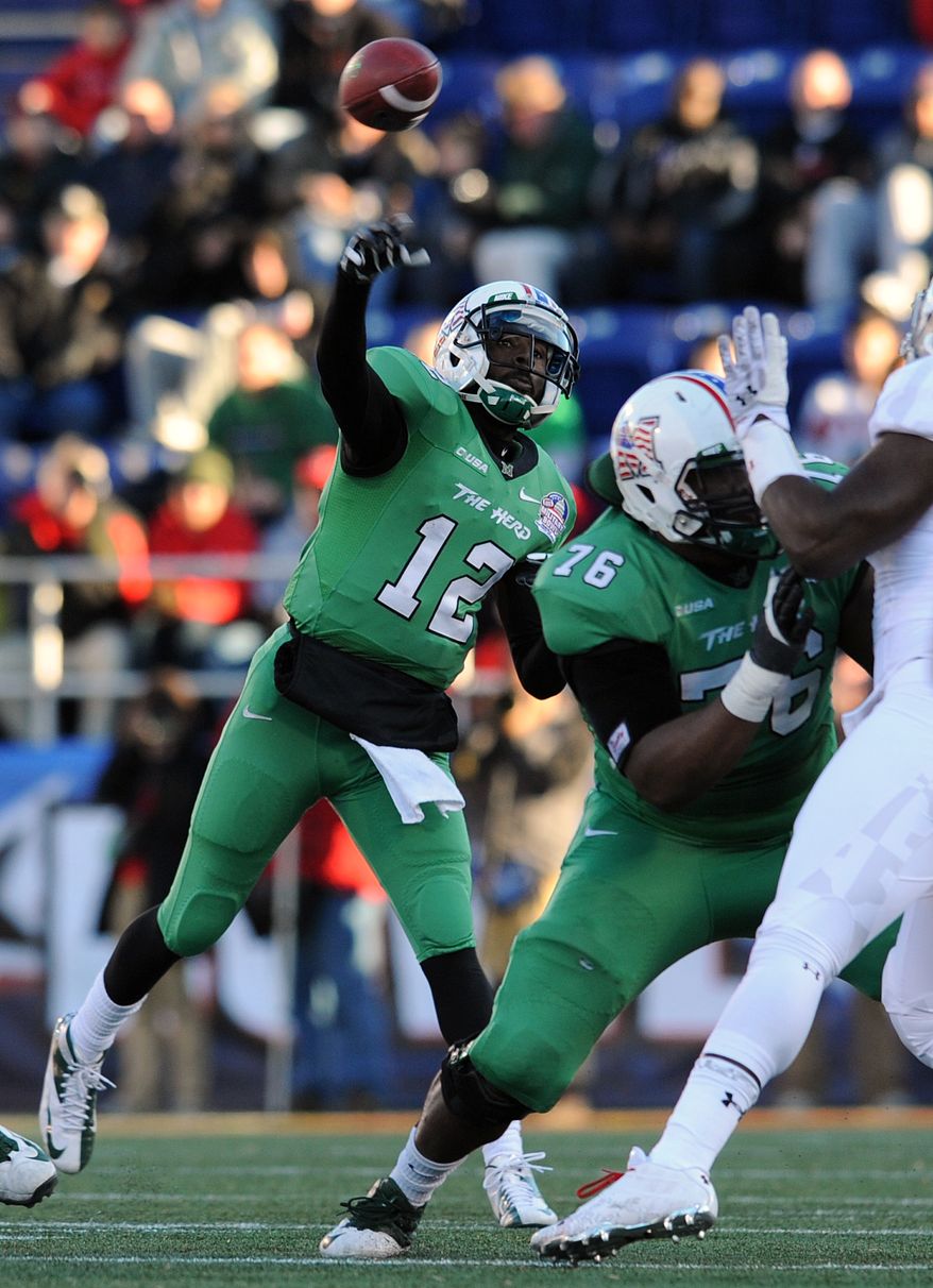 Marshall quarterback Raheem Cato (12) throws as Maryland applies pressure in the first half of the Military Bowl NCAA college football game on Friday, Dec. 27, 2013, in Annapolis, Md.(AP Photo/Gail Burton)