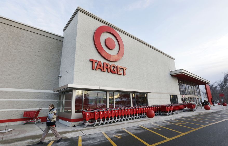 A passer-by walks near an entrance to a Target retail store in Watertown, Mass., in this Dec. 19, 2013, file photo. (AP Photo/Steven Senne, File)