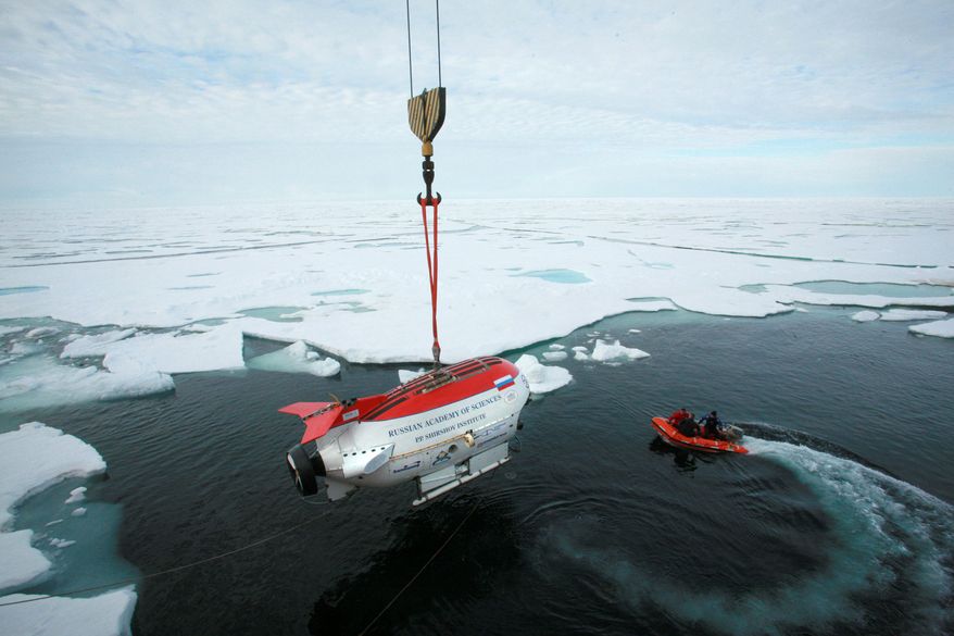 Chilling: In 2007, explorers in the oil-rich Arctic dropped two miniature submarines more than 2 miles beneath the ice at the North Pole to plant a Russian flag on the ocean floor. (Associated Press)