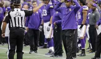 Minnesota Vikings head coach Leslie Frazier, right, disagrees with a call during the second half of an NFL football game against the Detroit Lions, Sunday, Dec. 29, 2013, in Minneapolis. (AP Photo/Ann Heisenfelt)