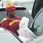 After cleaning out his locker at Redskins Park on Monday, quarterback Robert Griffin III heads to his car after a 3-13 season. He thanked Mike Shanahan for drafting him. (Associated Press)