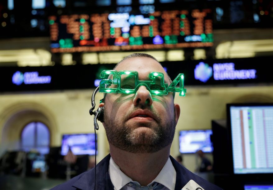 A trader on the floor at the New York Stock Exchange gets into the New Year's spirit during an abbreviated trading session, capping a stellar year for U.S. stock markets. (associated press)
