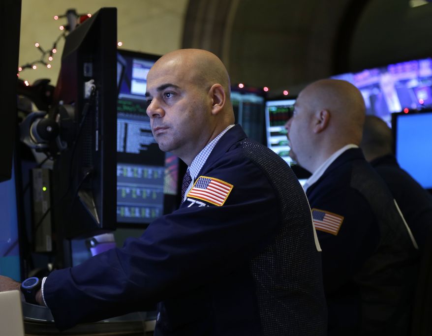 Traders work on the floor at the New York Stock Exchange in New York, Tuesday, Dec. 31, 2013. (AP Photo/Seth Wenig)