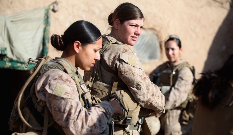 Marine Corps Sgt. Jessica Domingo (right) and Cpl. Daisy Romero, part of a female engagement team, worked with infantry Marines in Afghanistan by engaging women and children in support of the International Security Assistance Force. (Associated Press)