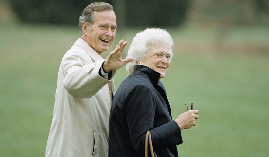 Then-President George H.W. Bush waves as he and first lady Barbara Bush leave the White House in Washington, Nov. 5, 1992, for a weekend trip to Camp David, Maryland. (AP Photo/Wilfredo Lee) ** FILE **
