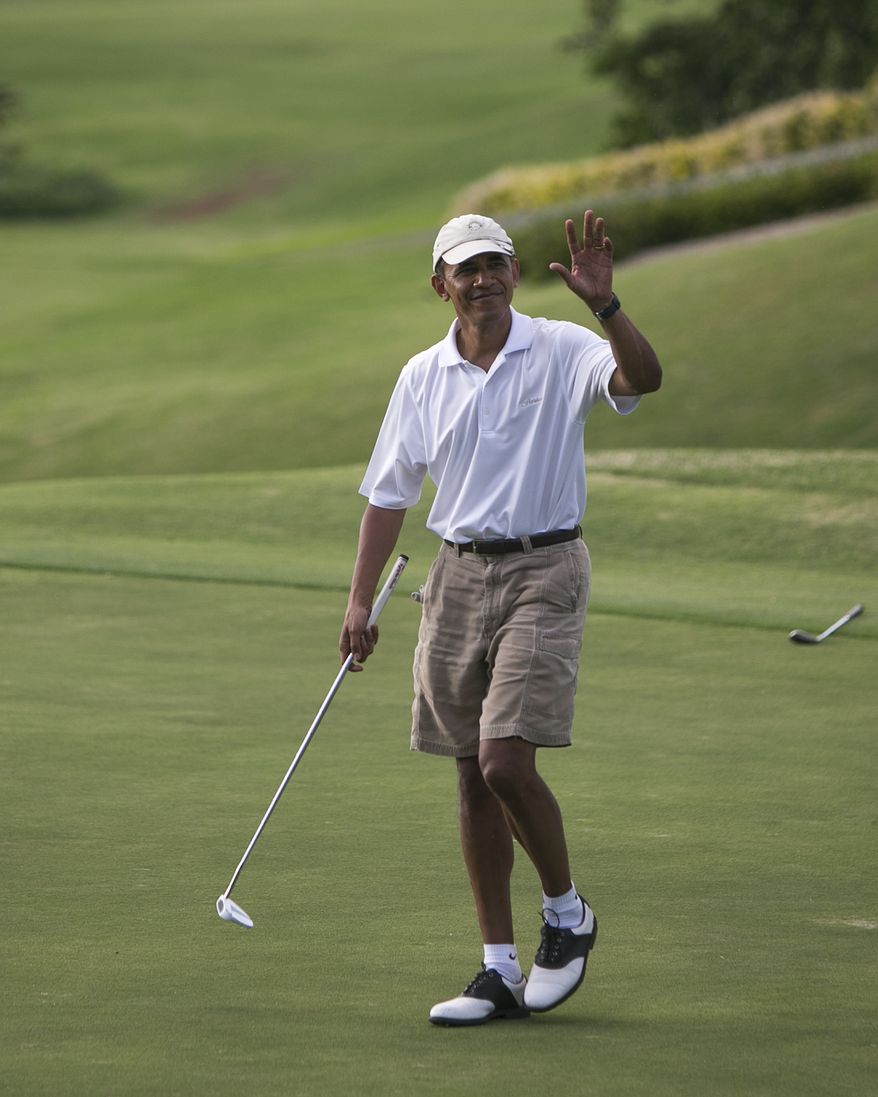 President Barack Obama waves to the crowd watching him play golf of the 18th green at the Mid Pacific Country Club, Wednesday, .Jan. 1, 2014 in Lanikai on the island of Oahu, in Hawaii. (AP Photo/Marco Garcia)