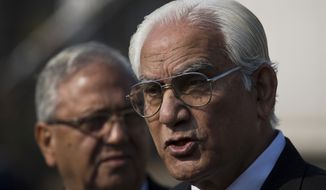 Ahmed Raza Kasuri, right, attorney of Pakistan&#39;s former president and military ruler Pervez Musharraf, briefs media about court proceeding with advocate Siddiq Mirza outside a court in Islamabad, Pakistan, Wednesday, Jan. 1, 2014. Musharraf failed to appear in court Wednesday for the second hearing in his high-profile treason case after authorities said they found an explosive device near his home.(AP Photo/B.K. Bangash)