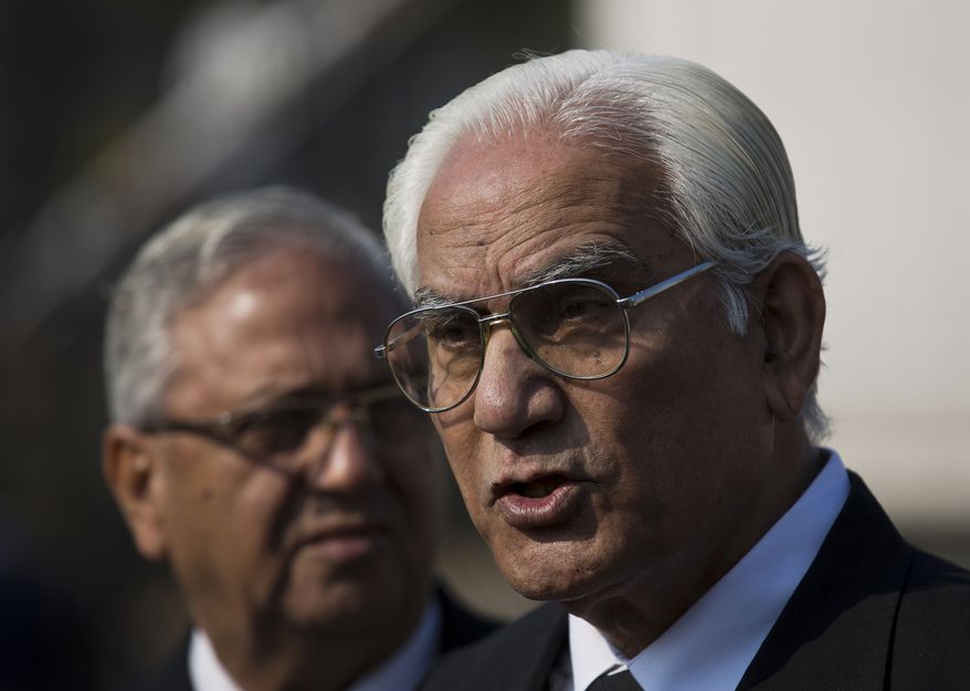Ahmed Raza Kasuri, right, attorney of Pakistan's former president and military ruler Pervez Musharraf, briefs media about court proceeding with advocate Siddiq Mirza outside a court in Islamabad, Pakistan, Wednesday, Jan. 1, 2014. Musharraf failed to appear in court Wednesday for the second hearing in his high-profile treason case after authorities said they found an explosive device near his home.(AP Photo/B.K. Bangash)