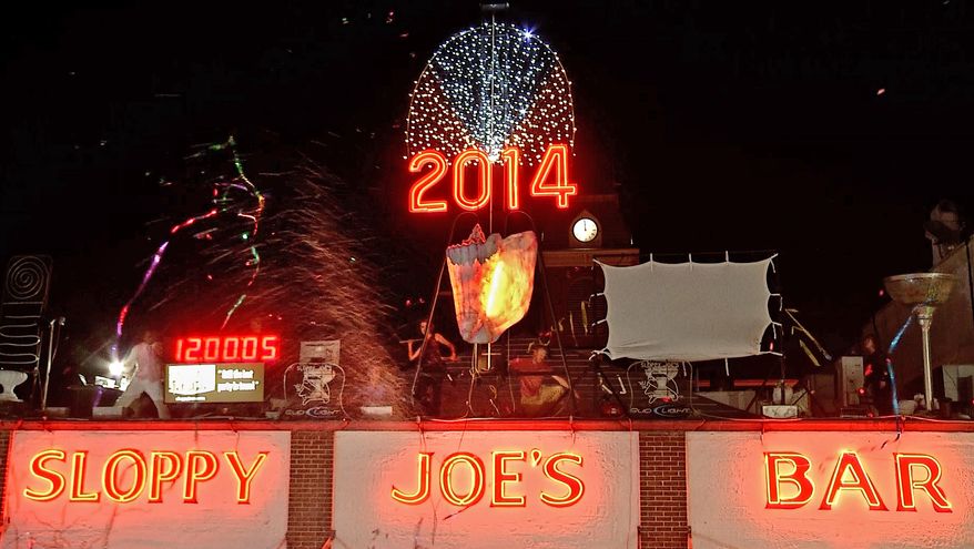 In this photo provided by the Florida Keys News Bureau, a large reproduction of a conch shell is lowered to the roof of Sloppy Joe's Bar in Key West, Fla., early Wednesday, Jan. 1, 2014. (AP Photo/Florida Keys News Bureau, Presley Adamson)