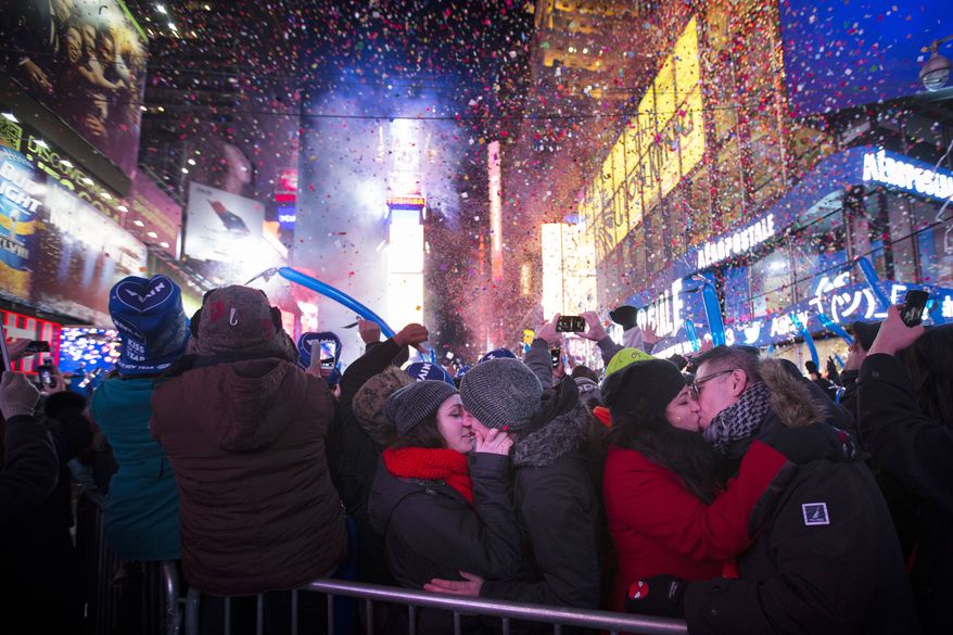Miranda Echerarria and Christian Prieto, of Niagra, N.Y. kiss at the stoke of midnight during the New Year's Eve celebrations in Times Square, Wednesday, Jan. 1, 2014, in New York. (AP Photo/John Minchillo)
