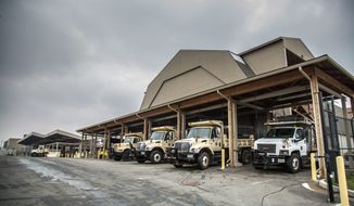 City vehicles loaded up with salt wait for their snow plows to be attached as they prepared on Thursday for the arrival of snow in Alexandria, Va. (andrew s. geraci/the Washington Times)
