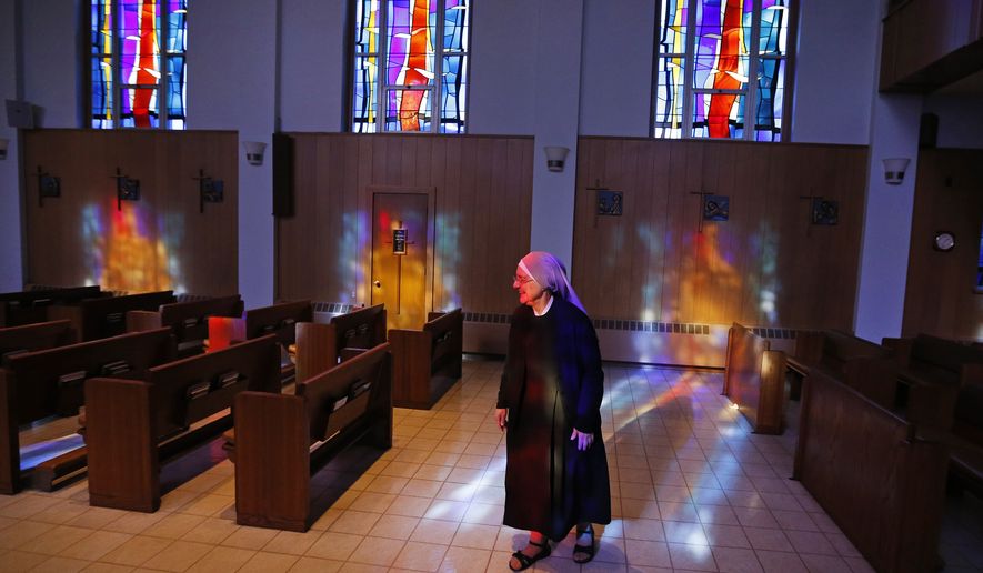Mother Patricia Mary walks in the chapel at the Mullen Home for the Aged, run by Little Sisters of the Poor, in Denver, Colo., Thursday, Jan. 2, 2014. (AP Photo/Brennan Linsley) ** FILE **