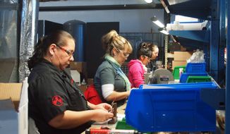 Magpul Industries is moving its manufacturing facility and corporate headquarters out of Colorado after the state legislature approved sweeping gun-control legislation in 2013. Here, Magpul employees in Erie, Colo., assemble firearms accessories and other products.(Photos by Stan Lukowicz)