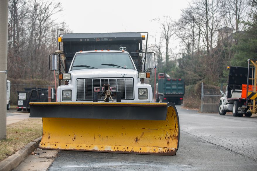 Snow plows are attached to the front of salt trucks as they prepare for the arrival of snow this week, in Alexandria, VA., Thursday, January 2, 2014. (Andrew S Geraci/The Washington Times)