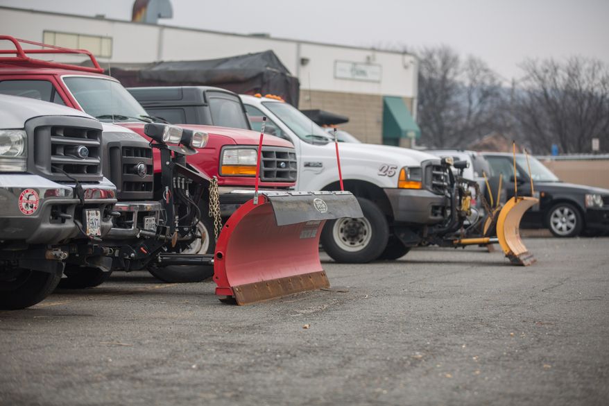Snow plows are attached to the front of salt trucks as they prepare for the arrival of snow this week, in Alexandria, VA., Thursday, January 2, 2014. (Andrew S Geraci/The Washington Times)