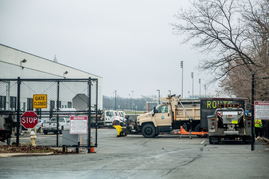 Snow plows are attached to the front of city vehicles as they prepare for the arrival of snow this week, in Alexandria, VA., Thursday, January 2, 2014. (Andrew S Geraci/The Washington Times)