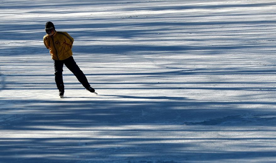 ** FILE ** A skater braves the cold weather as they make their way along the Rideau Canal skateway in Ottawa on Friday, Jan. 3, 2014. (AP Photo/The Canadian Press, Sean Kilpatrick)