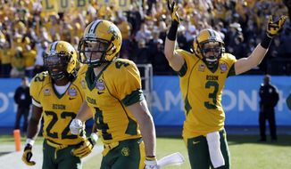 North Dakota State&#39;s Sam Ojuri, left, Ryan Smith (4), and Trevor Gebhart (3) celebrate a touchdown by Smith in the first half of the FCS championship NCAA college football game against Towson, Saturday, Jan. 4, 2014, in Frisco, Texas. (AP Photo/Tony Gutierrez)