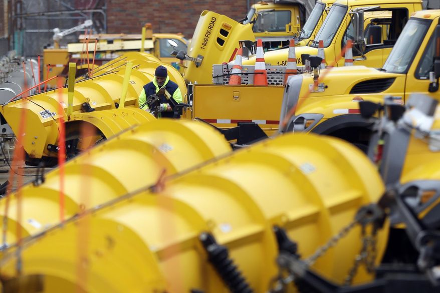 A worker at the Pennsylvania Department of Transportation facility makes preparations for an expected winter storm, Thursday, Jan. 2, 2014, in Philadelphia. (AP Photo/Matt Rourke)