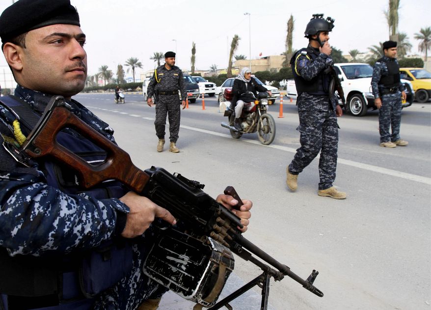 Old Ways: Iraqis have posted checkpoints along roads rather than adopting counterinsurgency practices as taught by U.S. forces, says an architect of the U.S. troop surge that reduced violence in Iraq by 90 percent and led to the military exodus ordered by President Obama in 2011. Trained Iraqi defense forces have since been unable to contain al Qaeda. (Associated Press photographs)
