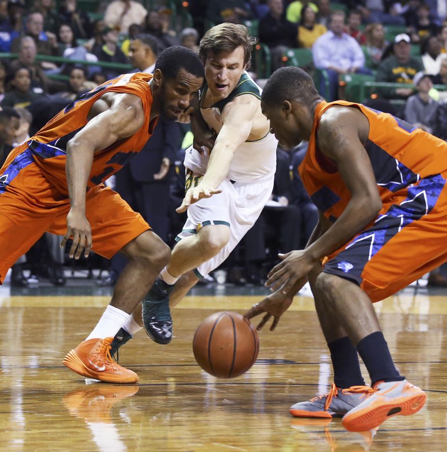 Savannah State forward Joshua Montgomery, left, reaches for a loose ball with Baylor guard Brady Heslip, center, and Savannah State's Terel Hall during the second half of an NCAA college basketball game, Friday, Jan. 3, 2014, in Waco, Texas. (AP Photo/Waco Tribune Herald, Rod Aydelotte)
