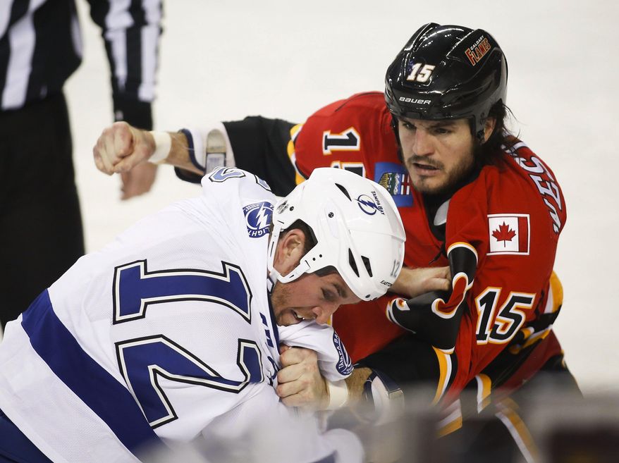 Tampa Bay Lightning's Ryan Malone, left, fights with Calgary Flames' Kevin Westgarth during the first period of an NHL hockey game Friday, Jan. 3, 2014, in Calgary, Alberta. (AP Photo/The Canadian Press, Jeff McIntosh) **FILE**