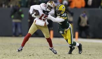 San Francisco 49ers wide receiver Michael Crabtree (15) runs against Green Bay Packers cornerback Davon House (31) after catching a pass from the 49ers quarterback Colin Kaepernick during the second half of an NFL wild-card playoff football game, Sunday, Jan. 5, 2014, in Green Bay, Wis. (AP Photo/Mike Roemer) 