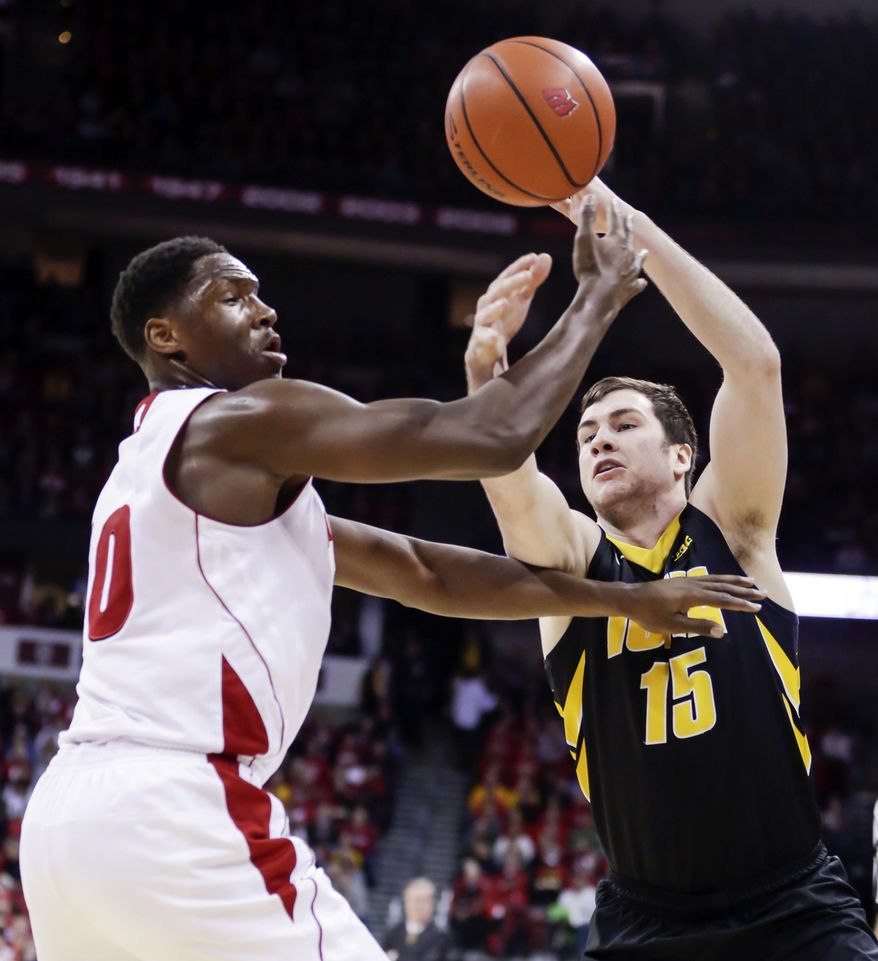 Wisconsin's Nigel Hayes, left, knocks the ball loose from Iowa's Zach McCabe during the first half of an NCAA college basketball game Sunday, Jan. 5, 2014, in Madison, Wis. (AP Photo/Andy Manis)