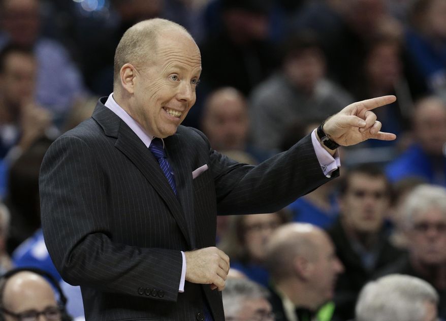 Cincinnati head coach Mick Cronin directs his team during the first half of an NCAA college basketball game against Memphis Saturday, Jan. 4, 2014, in Memphis, Tenn. (AP Photo/Mark Humphrey)