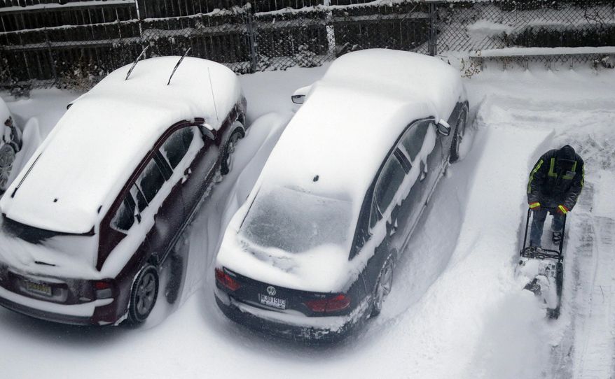 A man plows snow in a parking lot covered in snow following an overnight snow storm that hit the northern New Jersey region, Friday, Jan. 3, 2014, in Jersey City, N.J. New Jersey Gov. Chris Christie declared a state of emergency Thursday, urging residents to stay home. Schools were closed as temperatures reached below 20 degrees with wind-chills below zero in some places. (AP Photo/Julio Cortez)