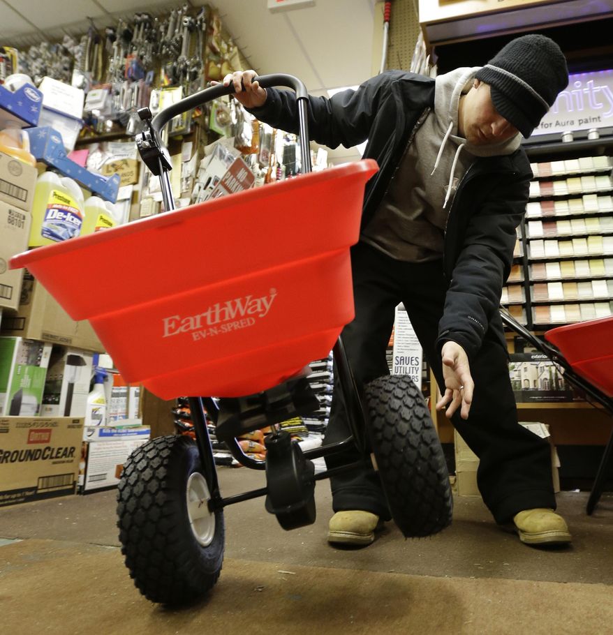 Marco Iuele inspects a salt spreader while shopping at Meadowlands Hardware, Thursday, Jan. 2, 2014, in East Rutherford, N.J. Snow and bone-chilling temperatures are expected for Thursday night with substantial accumulation predicted. (AP Photo/Julio Cortez)