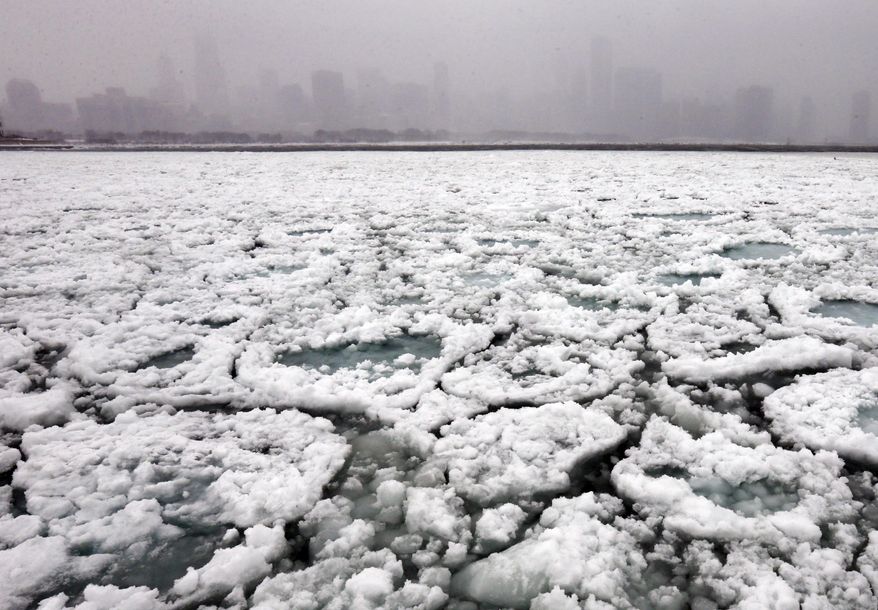 The Chicago skyline and a freezing Lake Michigan are seen from the Museum Campus in Chicago on Sunday, Jan. 5, 2014. Sunday night temperatures will drastically drop to about minus 20 degrees. (AP Photo/Nam Y. Huh)