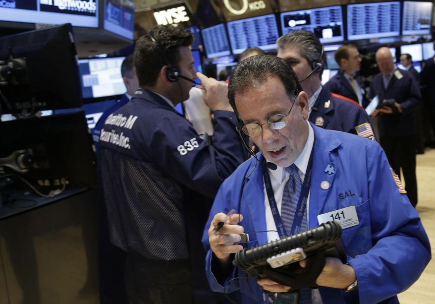 FILE - In this Tuesday, Dec. 31, 2013 file photo, traders work on the floor at the New York Stock Exchange in New York. European stocks edged higher on Friday, Jan. 3, 2014, recovering from a bad first day of the year, but Asian markets closed lower following declines on Wall Street. (AP Photo/Seth Wenig, File)