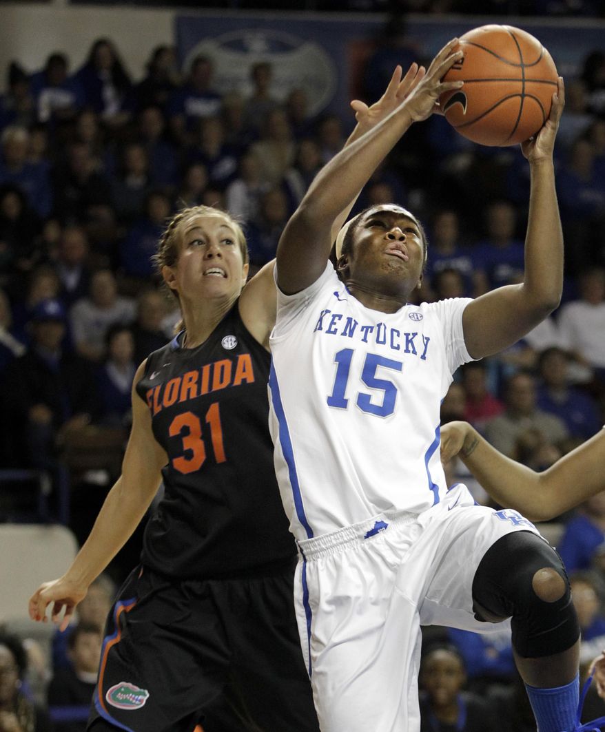 Kentucky's Linnae Harper (15) shoots under pressure from Florida's Lily Svete (31) during the first half of an NCAA college basketball game on Sunday, Jan. 5, 2014, in Lexington, Ky. (AP Photo/James Crisp)