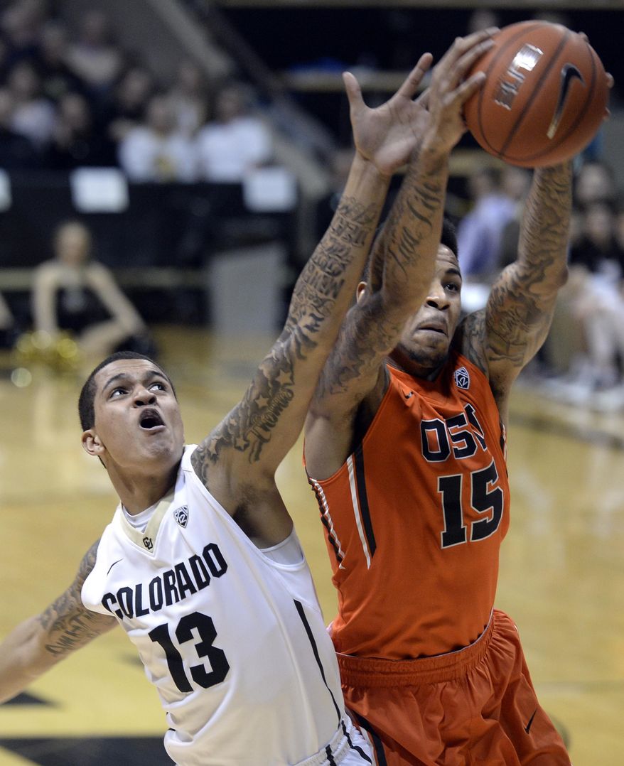 Colorado's Dustin Thomas fights for a rebound with Oregon State's Eric Moreland during an NCAA college basketball game Thursday, Jan. 2, 2014, in Boulder, Colo. (AP Photo/Daily Camera, Jeremy Papasso) NO SALES