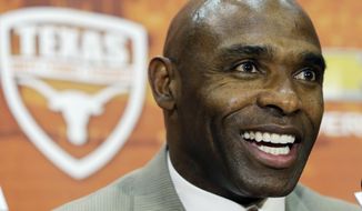 Charlie Strong answers questions during an NCAA college football news conference where he was introduced as the new Texas football coach, Monday, Jan. 6, 2014, in Austin, Texas. Strong acknowledged the historical significance of being the school&#39;s first African-American head coach of a men&#39;s sport. He takes over for Mack Brown, who stepped down last month after 16 seasons. (AP Photo/Eric Gay)