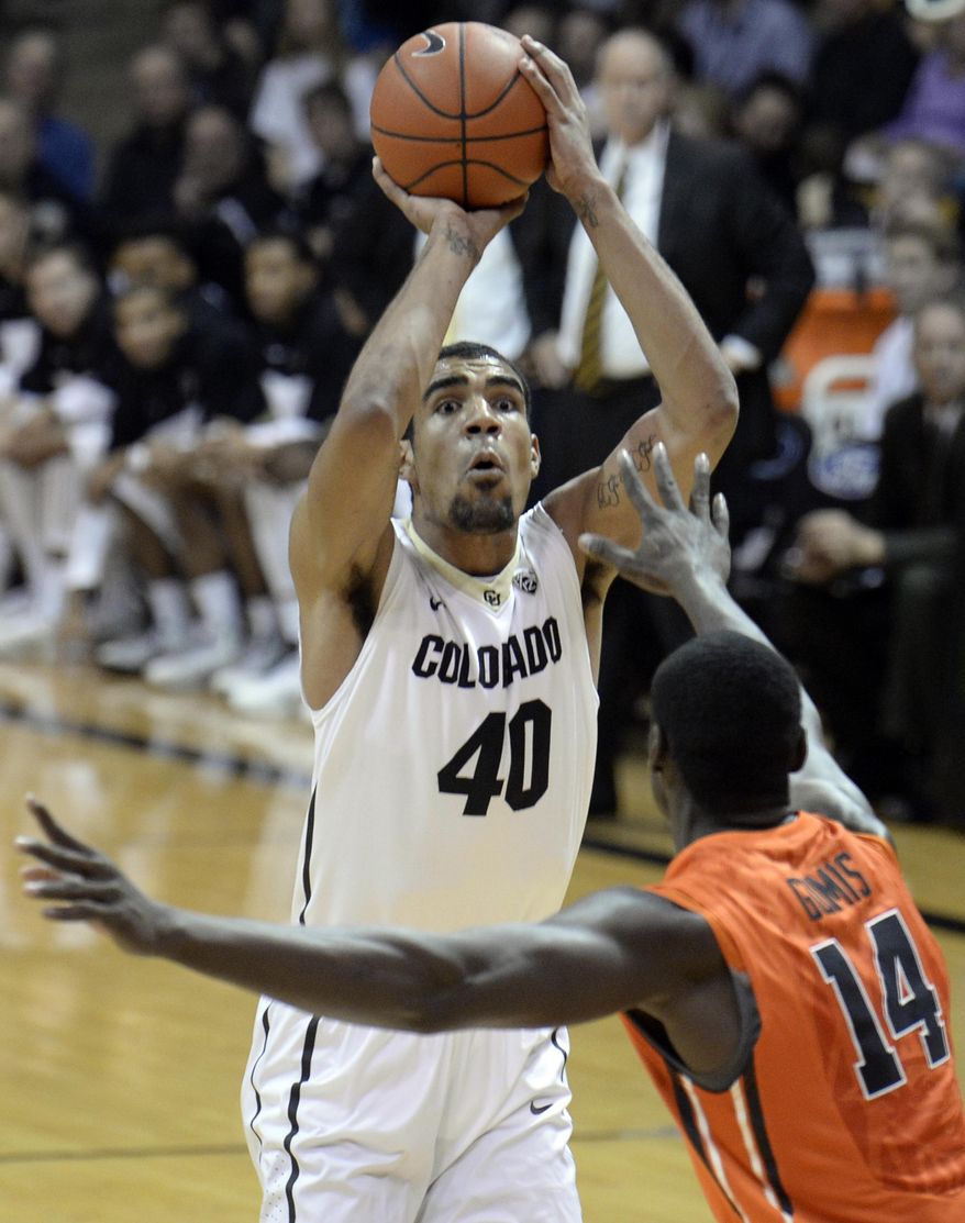 Colorado's Josh Scott takes a shot over Oregon State's Daniel Gomis during an NCAA college basketball game Thursday, Jan. 2, 2014, in Boulder, Colo. (AP Photo/Daily Camera, Jeremy Papasso) NO SALES