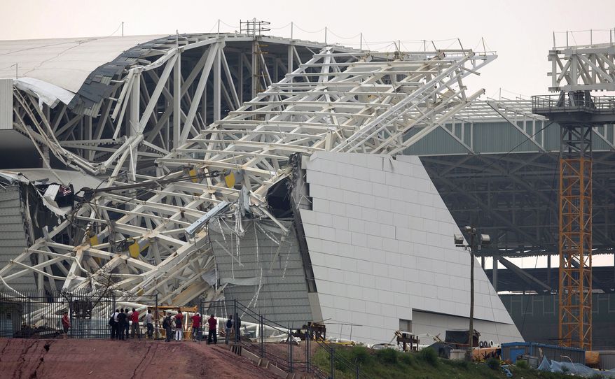 FILE - In this Nov. 27, 2013 file photo, a buckled metal structure sits on a part of the Itaquerao Stadium in Sao Paulo, Brazil. A news report cites Sao Paulo state Labor Ministry official Luis Antonio Medeiros as saying the man who operated the crane that collapsed at the city's World Cup stadium had worked 18 days in a row. Two construction workers were killed in the accident, which remains under investigation. The stadium is slated to host the 2014 World Cup opener. (AP Photo/Andre Penner, File)