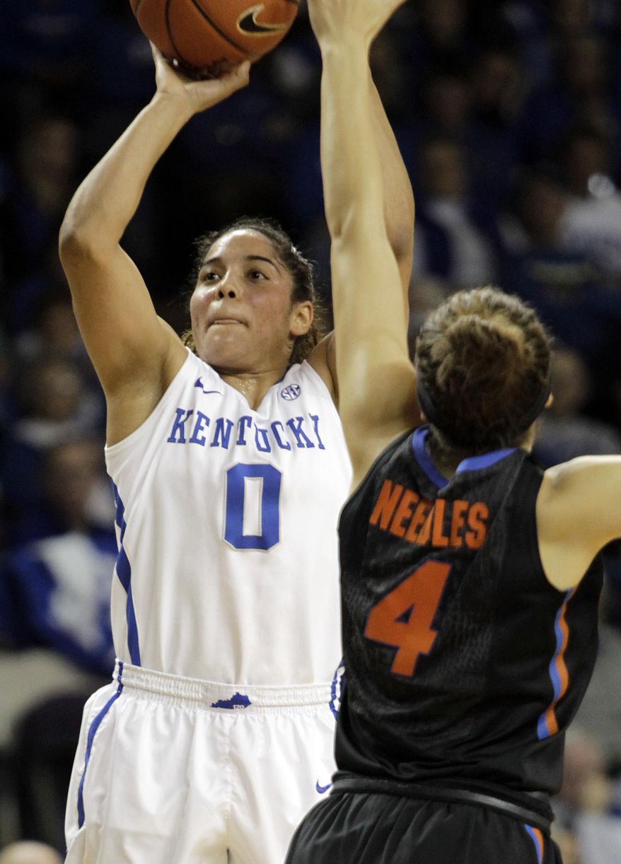 Kentucky's Jennifer O'Neill (0) shoots near Florida's Carlie Needles (4) during the first half of an NCAA college basketball game on Sunday, Jan. 5, 2014, in Lexington, Ky. (AP Photo/James Crisp)