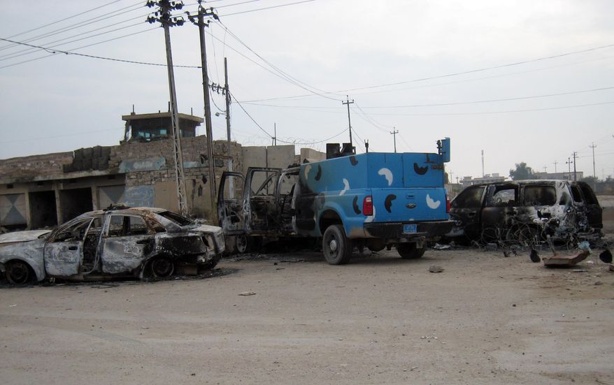Police vehicles look damaged in front of an abandoned police station after clashes between the Iraqi army and al-Qaeda fighters in Fallujah, 40 miles (65 kilometers) west of Baghdad, Iraq, Sunday, Jan. 5, 2014. Lt. Gen. Rasheed Fleih, a senior Iraqi military commander said it will take a few days to fully dislodge al-Qaida-linked fighters from Fallujah and Ramadi. (AP Photo)