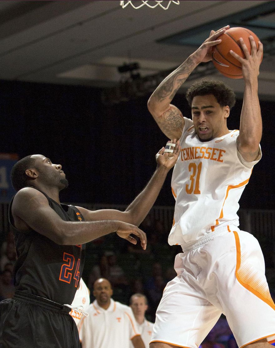 FILE - In this Nov. 28, 2013 file photo, Tennessee's Quinton Chievous, right, pulls down a rebound as UTEP's Justin Crosgile watches during the first half of an NCAA college basketball game in Paradise Island, Bahamas. UTEP officials said Tuesday, Jan. 7, 2014, that three players, including Crosgile, have been kicked off the men’s basketball team after they bet on at least one sporting event. (AP Photo/Bahamas Visual Services, Dante Carrer, File)