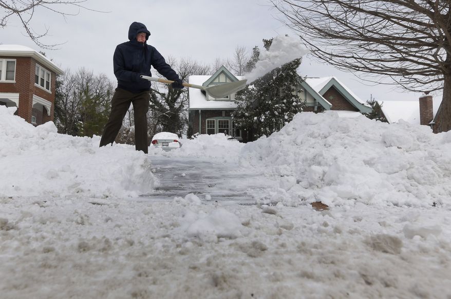 Ralph Wafer clears his driveway of snow outside his home Tuesday, Jan. 7, 2014, in St. Louis. As Missourians muddled through another frigid day Tuesday, the worst cold snap in nearly two decades was about to come to an end but many roads remained partly snow-covered two days after a winter storm dumped several inches of snow. (AP Photo/Jeff Roberson)