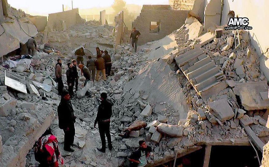 In this Monday, Jan. 6, 2014 citizen journalism image provided by Aleppo Media Center, AMC, which has been authenticated based on its contents and other AP reporting, Syrians inspect the rubble of destroyed buildings following a Syrian government airstrike in Aleppo, Syria. Syrian rebel groups battled one another Monday for control of a provincial capital, part of a vicious round of score settling targeting an al-Qaida affiliate that gained stature fighting President Bashar Assad but alienated many by imposing strict Islamic law. (AP Photo/Aleppo Media Center AMC)