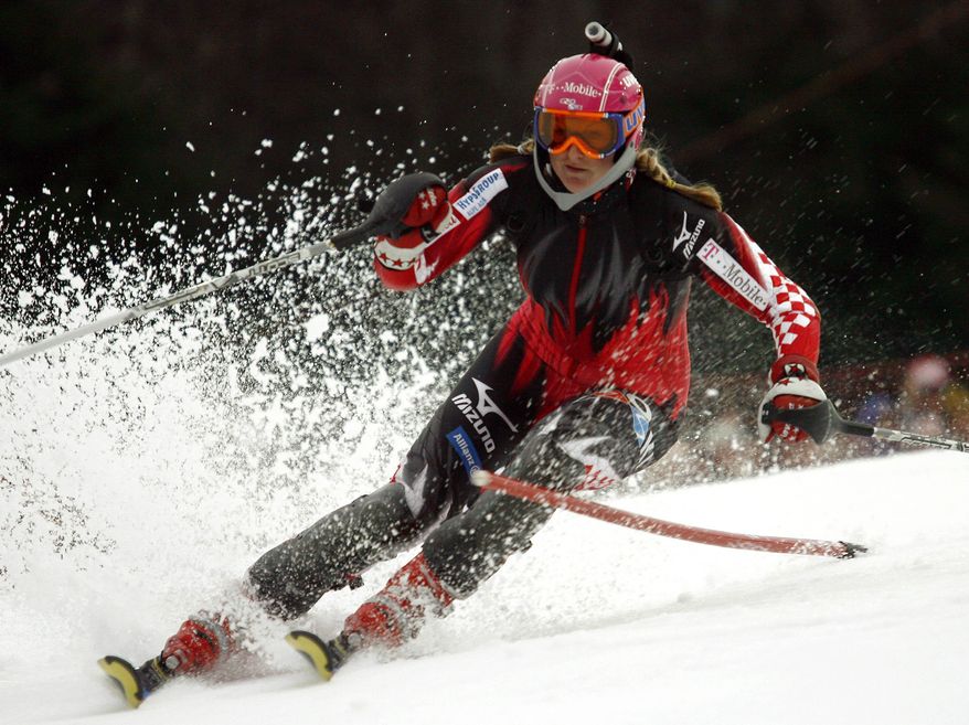 FILE - In this Jan. 4, 2007 file photo, reigning World Cup overall and slalom champion Janica Kostelic, of Croatia, carries a camera on her helmet as she tries the course before the first run of an Alpine ski world Cup women's slalom on Mt. Sljeme just outside Zagreb, Croatia. For adventure athletes, it's the new essential: a video of their exploits. Now only video action will do for a shoot-it-and-share-it generation of skiers and skydivers, snowboarders and bike riders. (AP Photo/Marco Trovati, File)