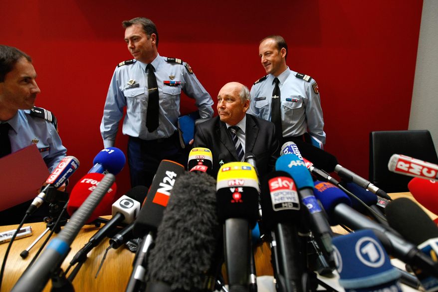 Albertville prosecutor Patrick Quincy, center, arrives with investigators for a press conference in the Albertville law court, French Alps, Wednesday Jan. 8, 2014. Two minutes of footage from a camera on Michael Schumacher's ski helmet showed the Formula One great was clearly skiing off a groomed trail when he lost his balance and crashed, leaving him with critical head injuries, investigators said Wednesday. The investigators said they have ruled out problems with his skis, trail conditions and signage. Although they would not estimate Schumacher's speed, they said it was not considered a significant factor in the Dec. 29 crash at the Meribel resort in the French Alps. (AP Photo/Claude Paris)