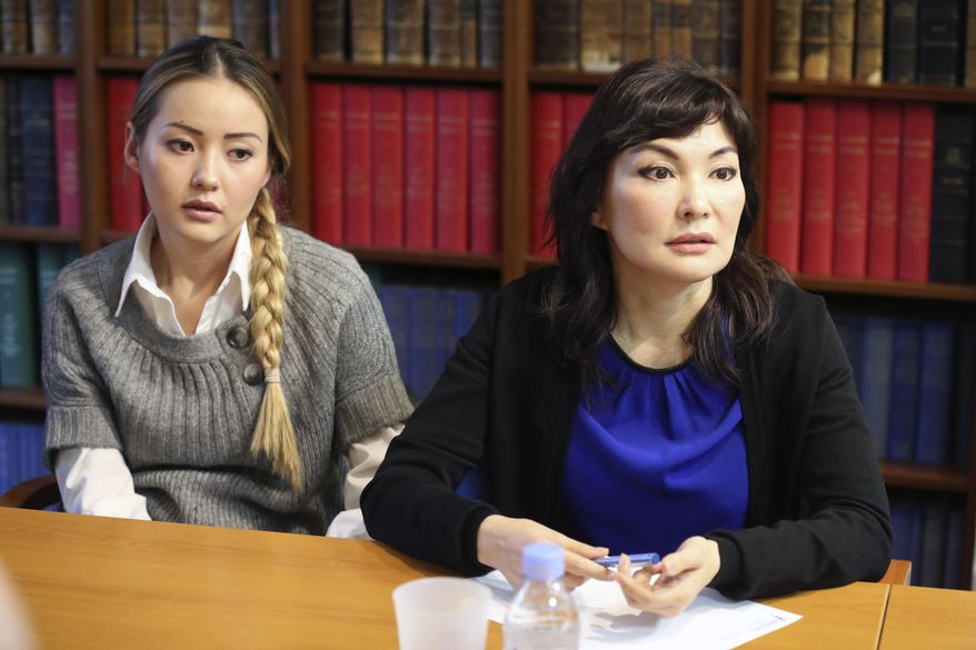 Mukhtar Ablyazov's wife Alma Shalabayeva, right, and daughter Madina Ablyazova, left, speak with journalists, during a press conference held with her lawyers, in Paris Tuesday Jan. 7, 2014. An opposition leader from a country that has been ruled by the same man since 1989, a former banker accused of siphoning off billions, Mukhtar Ablyazov has been jailed since police special forces seized him July 31 in the south of France. (AP Photo/Remy de la Mauviniere)