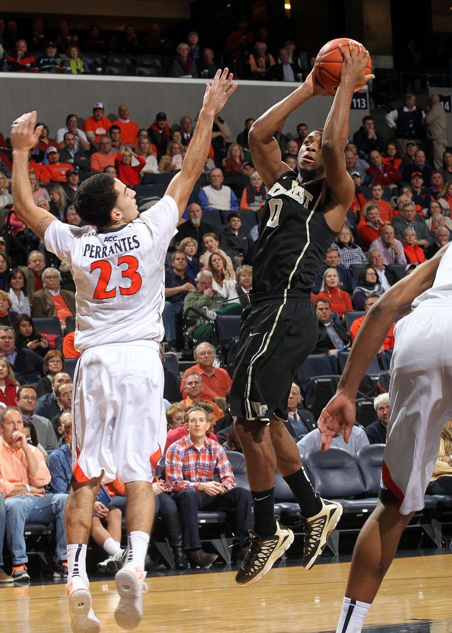 Wake Forest guard Codi Miller-McIntyre (00) shoots next to Virginia guard London Perrantes (23) during the first half of an NCAA college basketball game Wednesday, Jan. 8, 2014, in Charlottesville, Va. (AP Photo/Andrew Shurtleff)