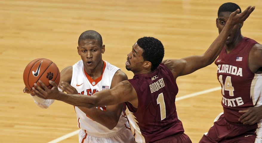 Florida State's Devon Bookert (1) gets a hand on the ball as Clemson's Jordan Roper looks to pass during the second half of an NCAA college basketball game at Littlejohn Coliseum in Clemson, S.C., on Thursday, Jan. 9, 2014. (AP Photo/Anderson Independent-Mail, Mark Crammer) GREENVILLE NEWS OUT SENECA JOURNAL OUT