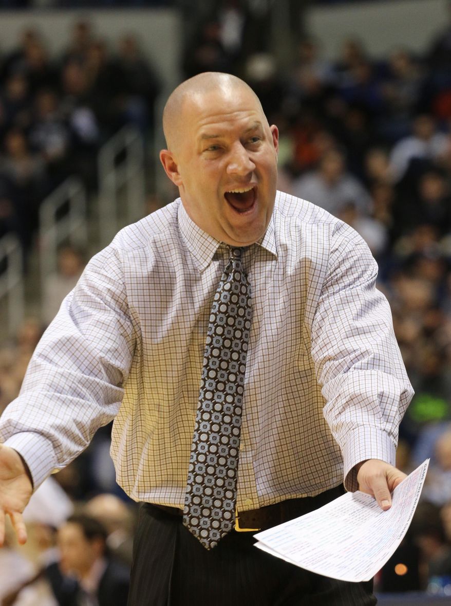 Marquette coach Buzz Williams yells at a player in the first half of their NCAA college basketball game at Xavier in Cincinnati, Thursday, Jan. 9, 2014. (AP Photo/Tom Uhlman)